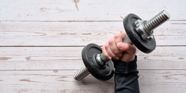 A hand holding a dumbbell.