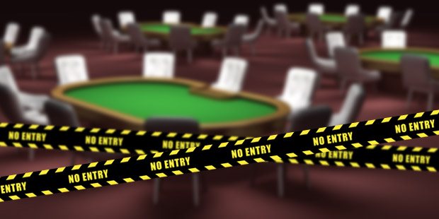 A no-entry sign with a poker table in the background