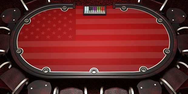 Overhead view of players at a poker table with the US flag printed on the table